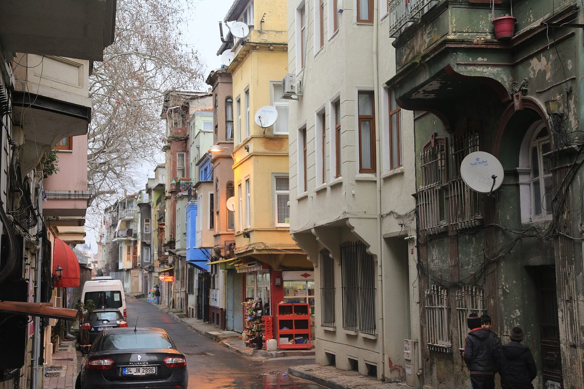 Colourful painted houses with bay windows lining a street in balat istanbul