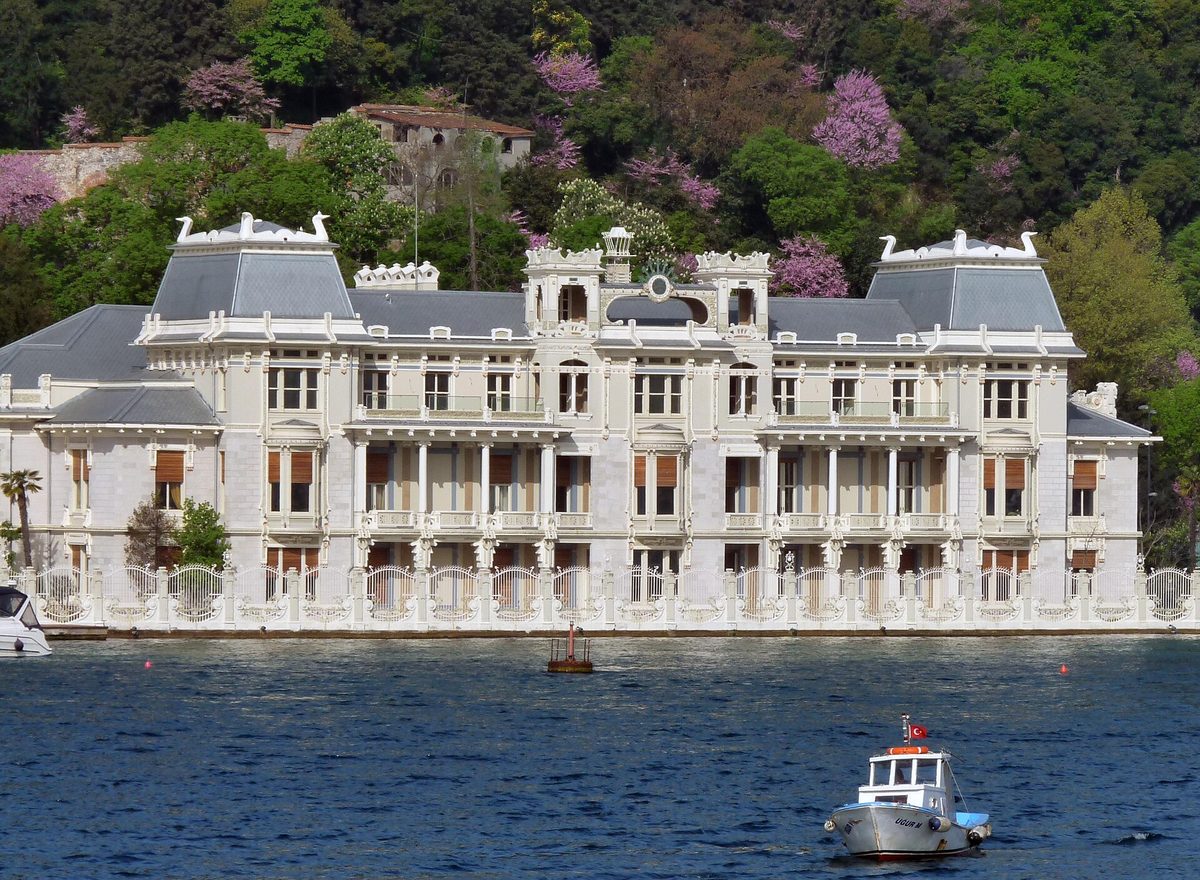 A grand white waterfront mansion on the Bosphorus shore in Istanbul seen from the water