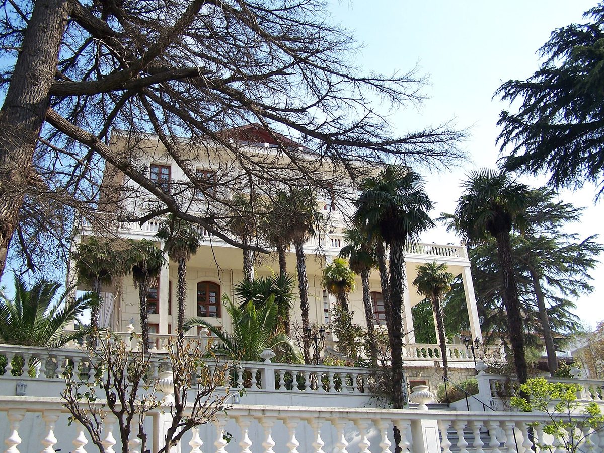 White nineteenth-century mansions with balustrades and palm trees on Buyukada in the Princes Islands
