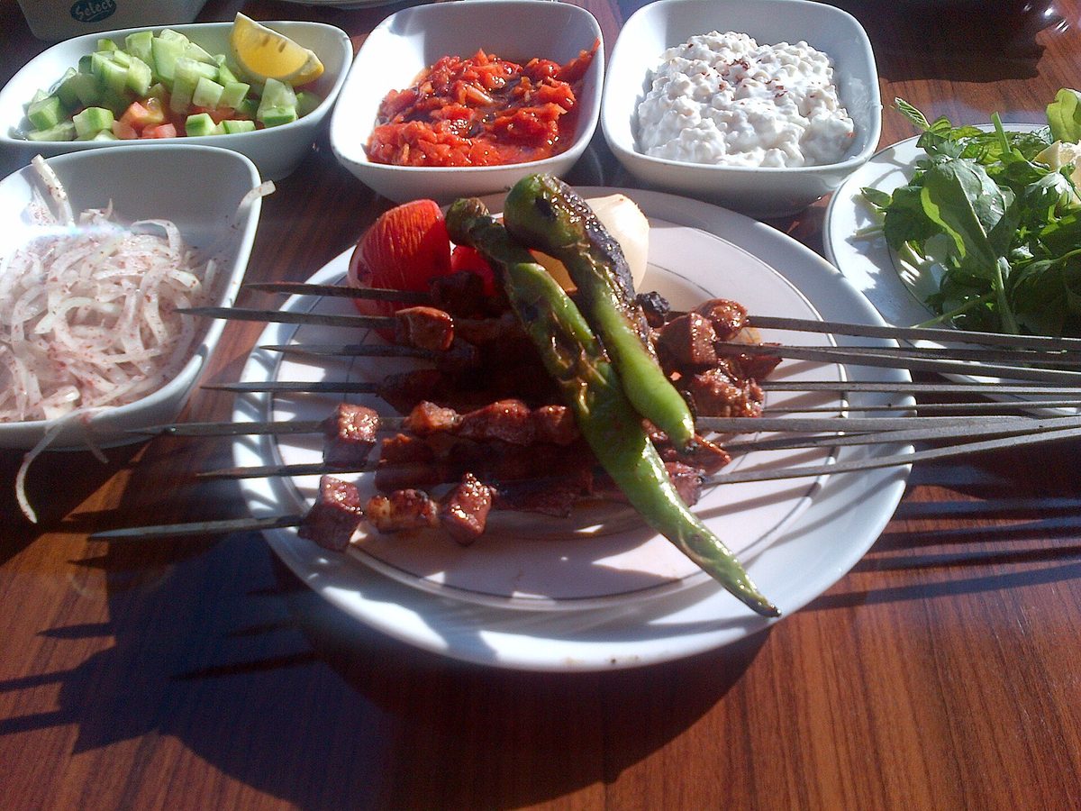 Skewers of liver kebab with meze plates at one of the best restaurants in istanbul for grills