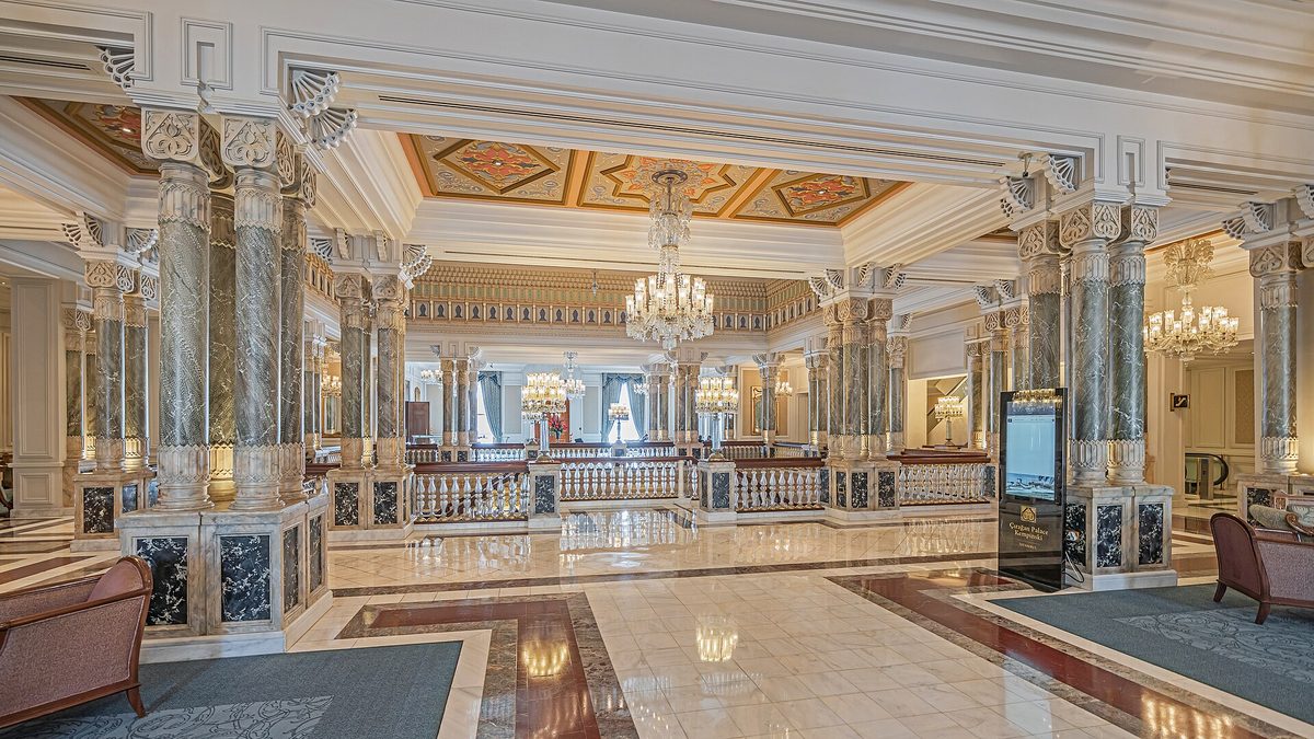 Marble columns and a grand staircase inside the lobby of Ciragan Palace Kempinski, one of the best hotels in Istanbul