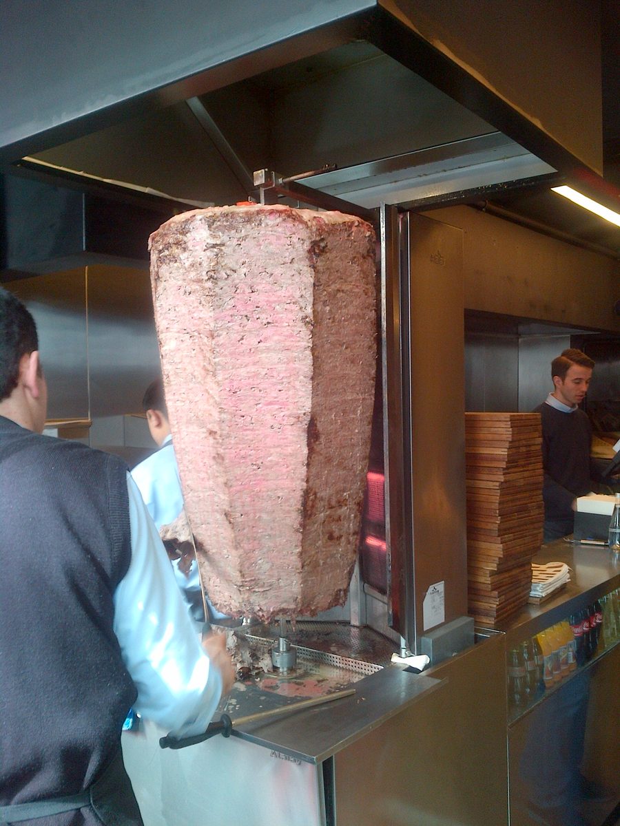 Doner being carved from a vertical spit at a shop in Kadikoy, Istanbul