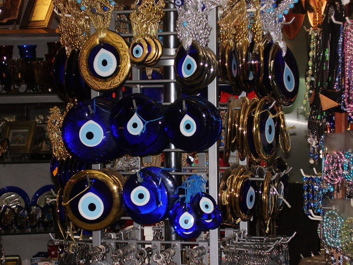 Blue and white evil eye nazar charms hanging in an Istanbul shop, the cheapest thing to buy in Istanbul