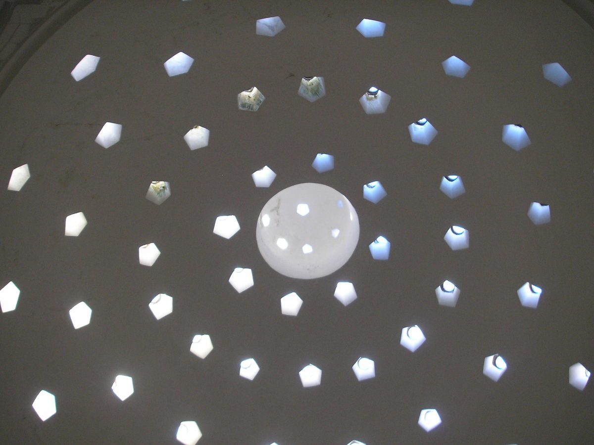 Star-shaped skylights piercing the dome of a historic Turkish bath in Istanbul
