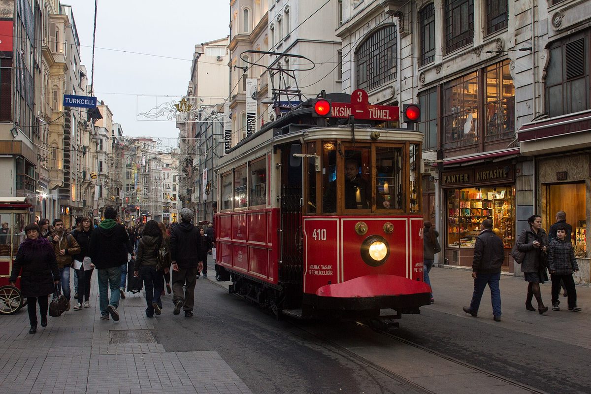 The historic red tram on Istiklal Avenue in Beyoglu, Istanbul, with crowds around it