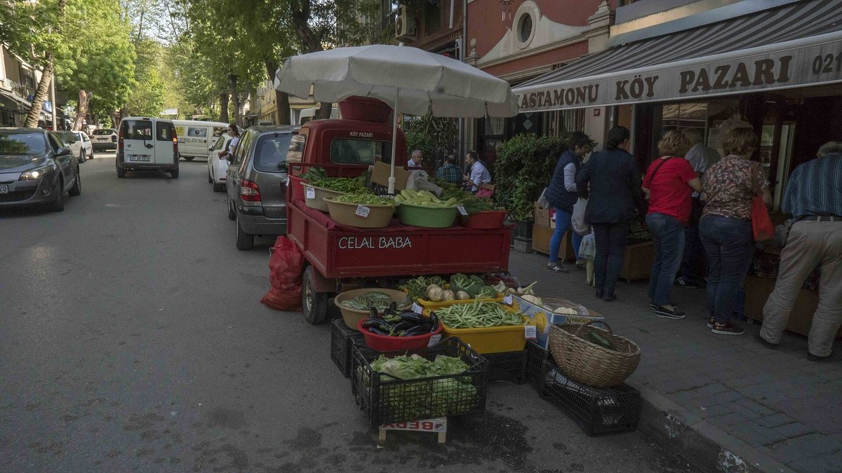 Icadiye Caddesi in Kuzguncuk with a greengrocer's stall, painted houses and shoppers