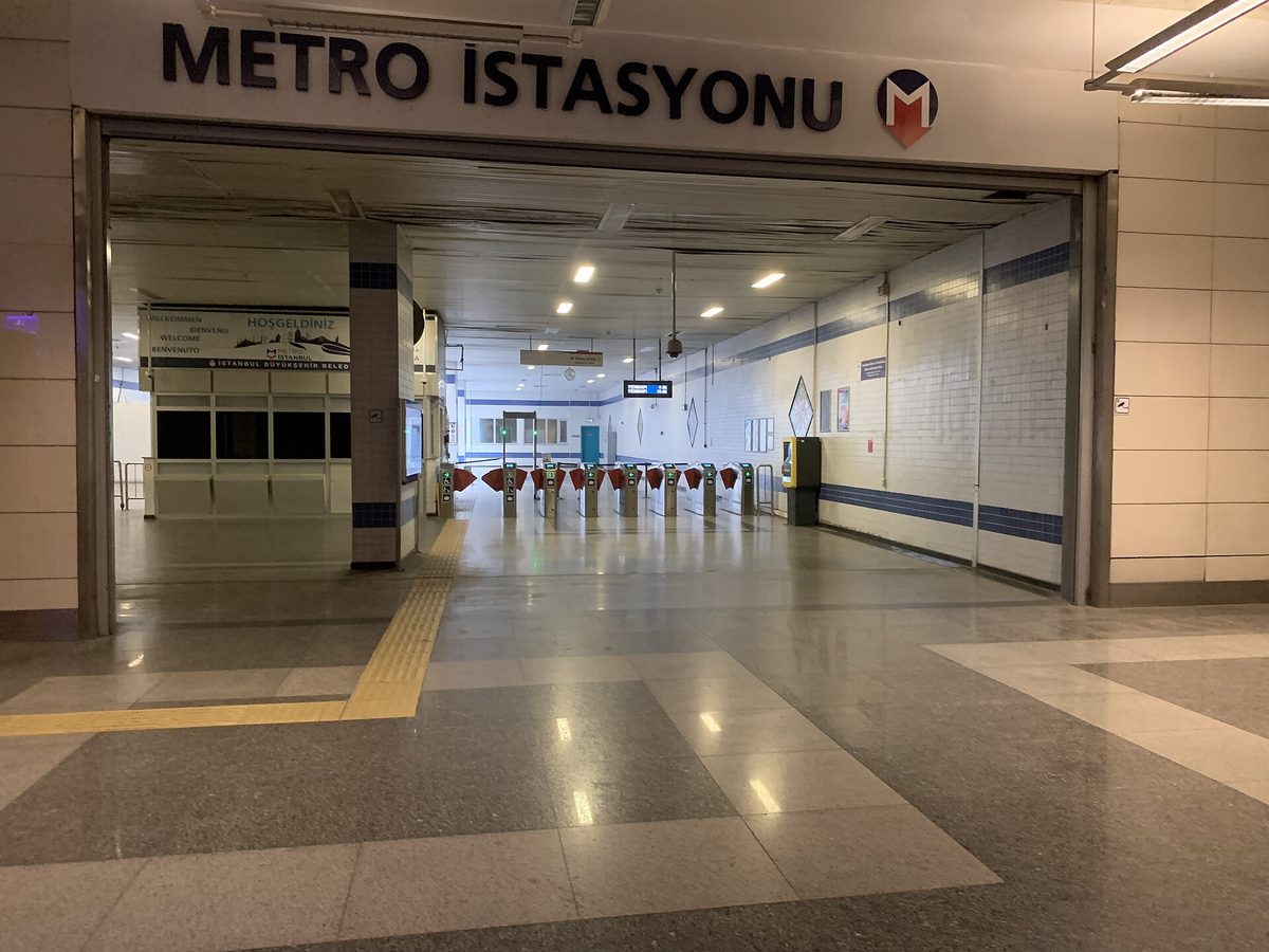 Turnstile gates at an Istanbul metro station entrance where you tap an Istanbulkart to enter