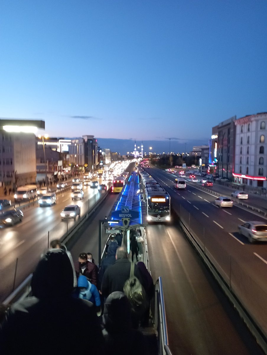 The segregated metrobus corridor running down the middle of an Istanbul motorway at dusk, a route covered by the Istanbulkart