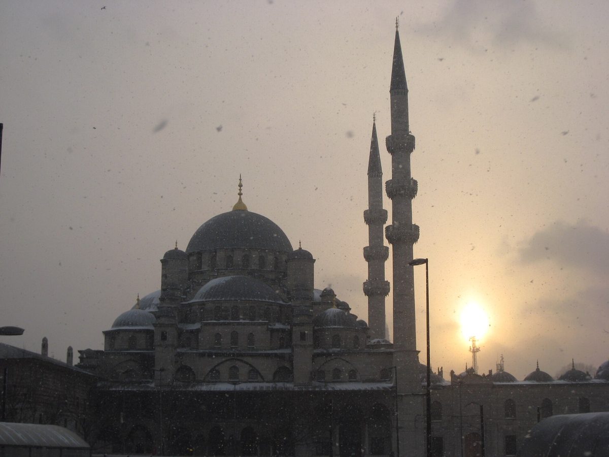 The New Mosque at Eminonu in Istanbul under falling snow at dusk