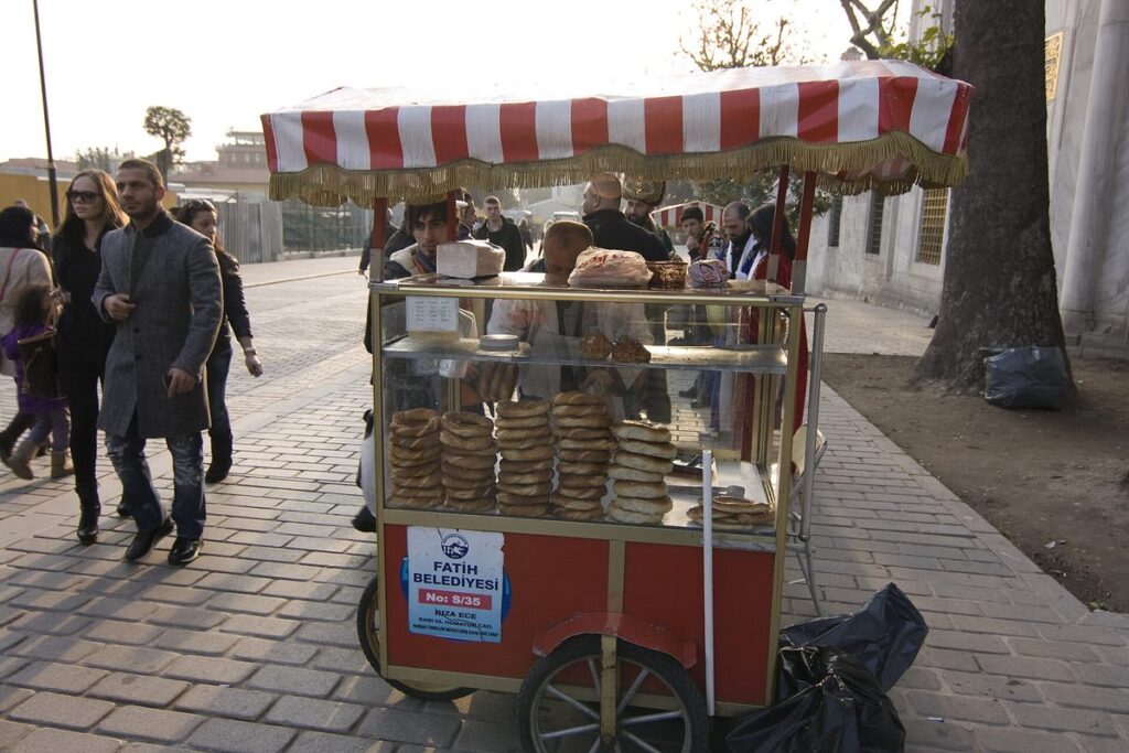 A red simit cart selling sesame bread rings on a street in Istanbul