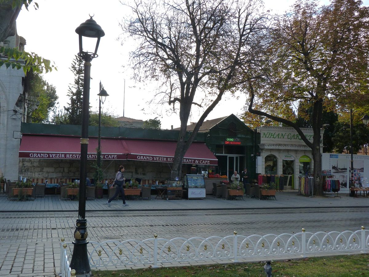 Restaurant terraces on the edge of Sultanahmet Square in Istanbul with tram tracks in front