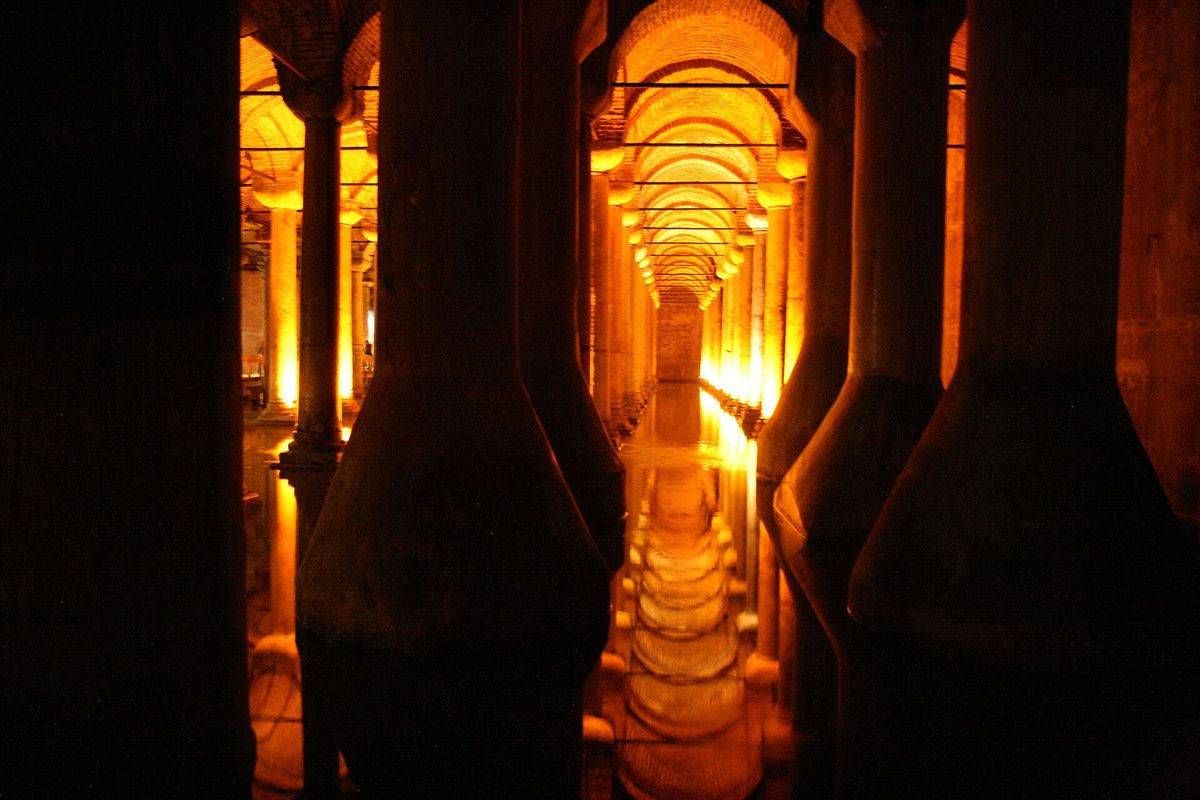 Rows of lit marble columns reflected in the water of the Basilica Cistern