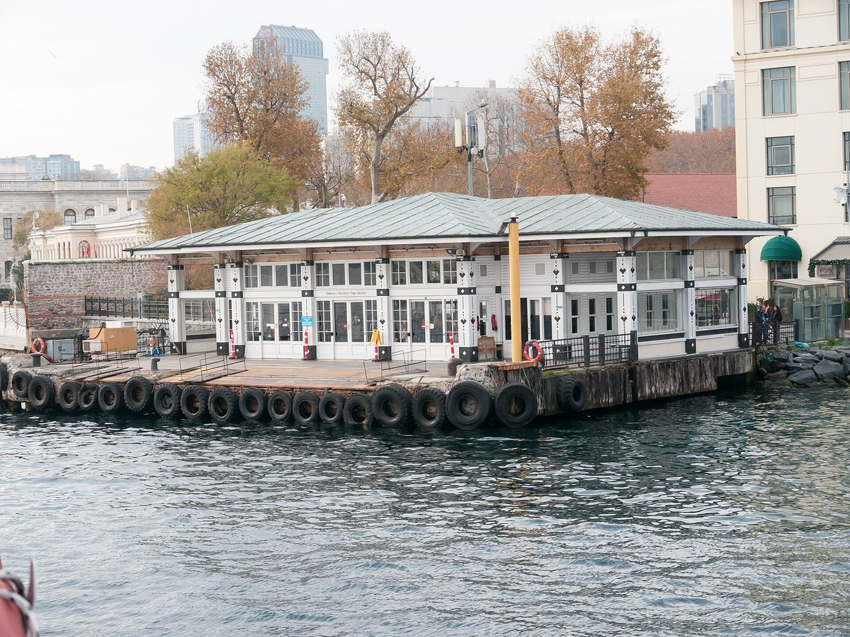 The white pavilion of the Barbaros Hayrettin Pasha ferry pier at Besiktas with tyres along the quay